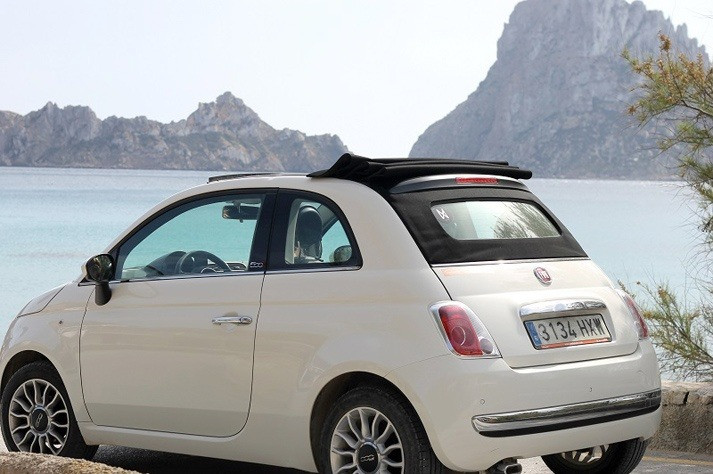 White Fiat 500 convertible in Ibiza with Es Vedrà