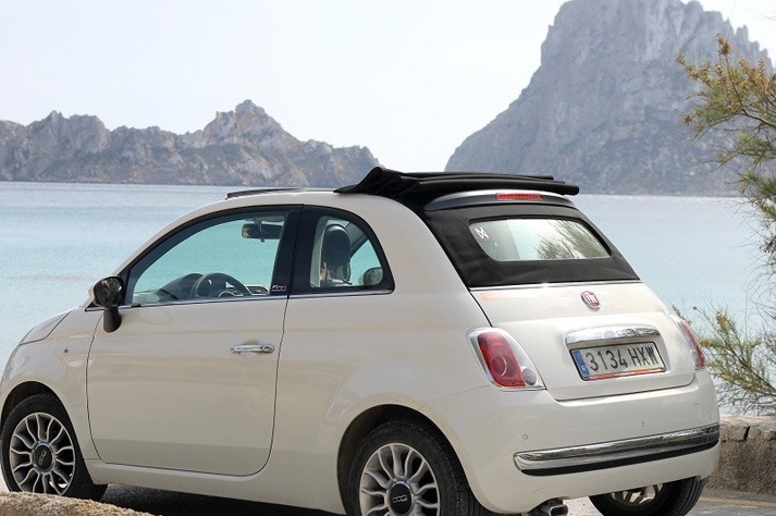 White Fiat 500 convertible in Ibiza with Es Vedrà