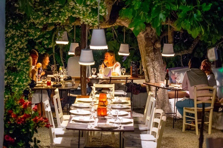 Romantic outdoor dinner in Ibiza under illuminated trees