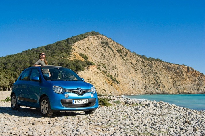 Blue Renault Twingo rental Ibiza, woman enjoying sun