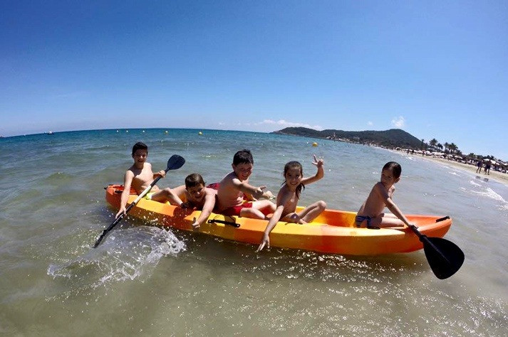 Kids kayaking on Ibiza beach, family holidays